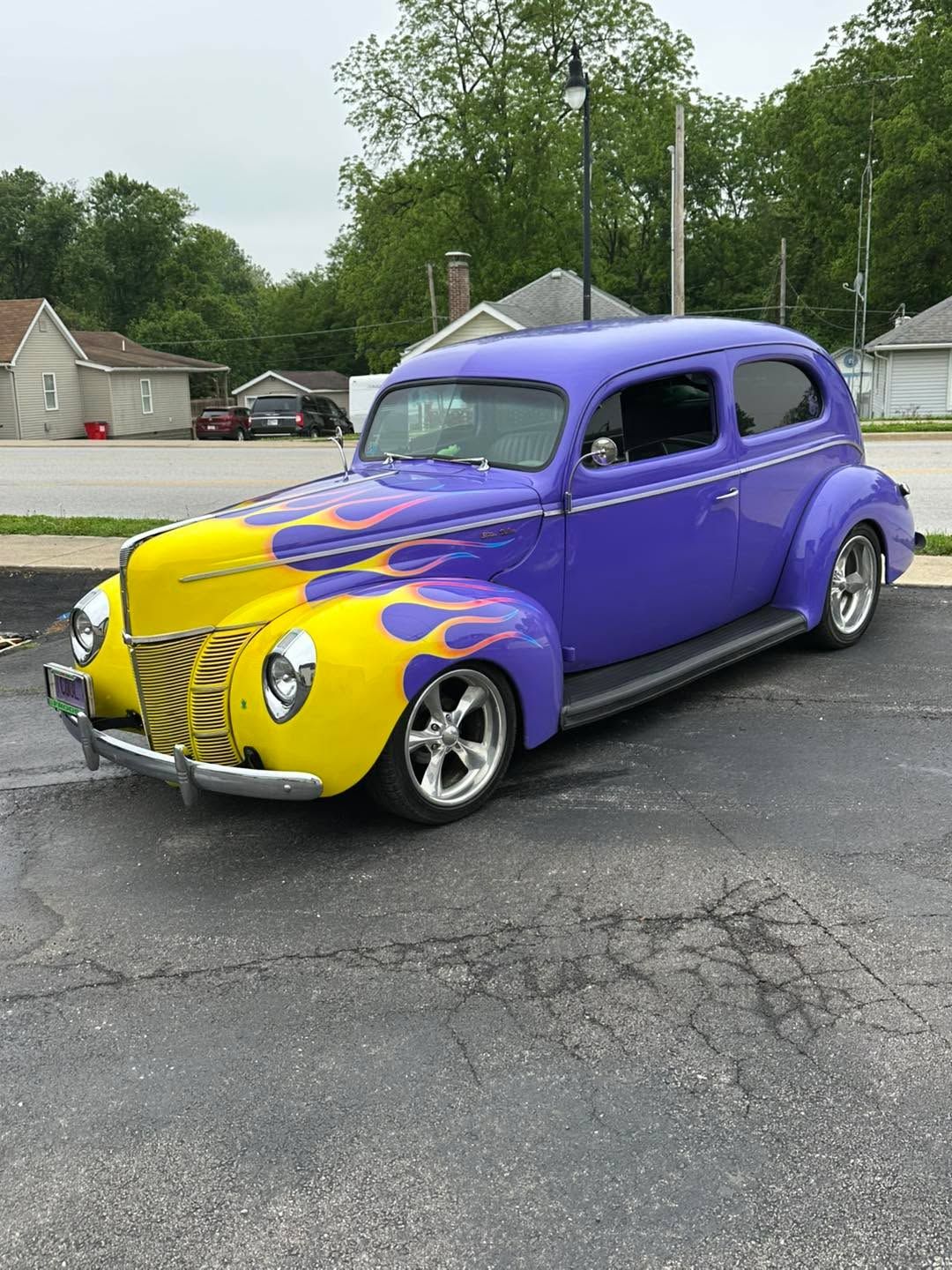 Purple and yellow hot rod at a car show